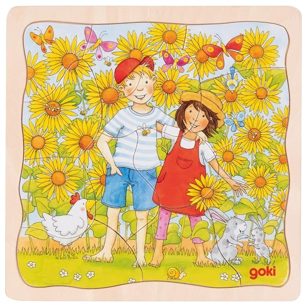 Children's puzzle with two children in a sunflower field, featuring a chicken and a rabbit, with 'goki' branding.