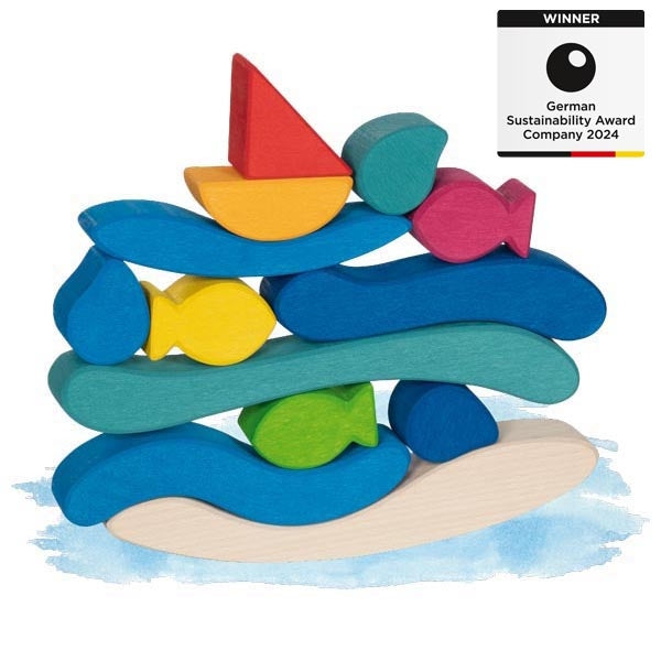 Colorful wooden toy stack with fish and sailboat shapes on a white background, featuring a sustainability award badge.