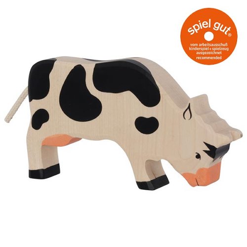 Wooden cow toy with black spots on a white background