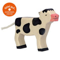 Wooden cow toy with black spots on a white background