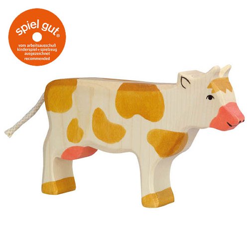 Stuffed cow toy with brown spots on a white background