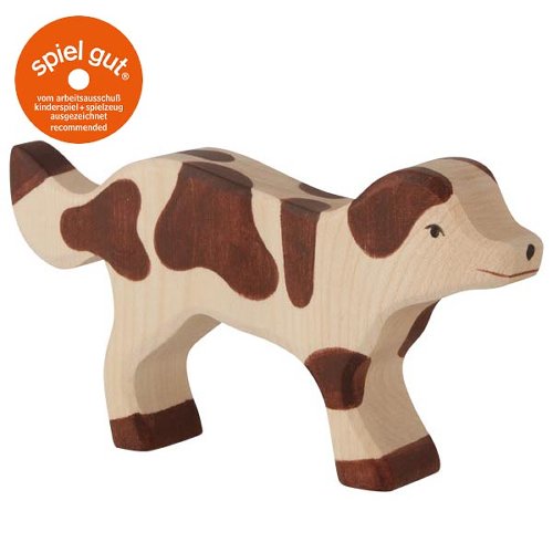 Wooden toy cow with brown patches on a white background