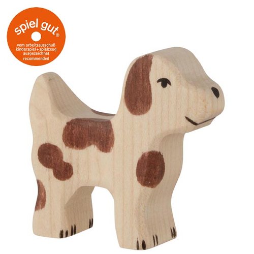 Wooden dog figurine with brown spots on a white background