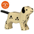 Wooden dog toy with black spots on a white background