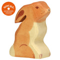 Wooden rabbit figurine with 'spiel gut' logo on a white background