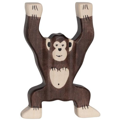 Wooden monkey toy hanging from branches on a white background