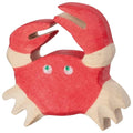 Red crab toy with green eyes on a white background