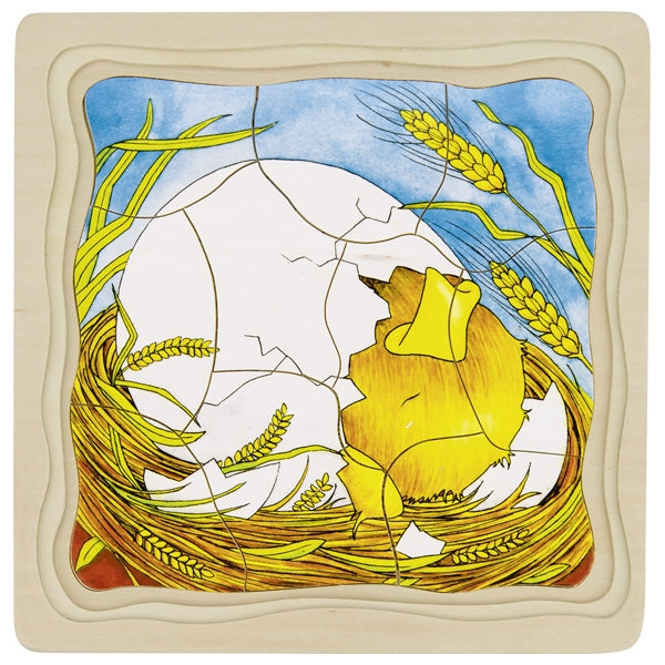 Illustration of a broken egg with a chick emerging, surrounded by wheat, on a decorative tile.
