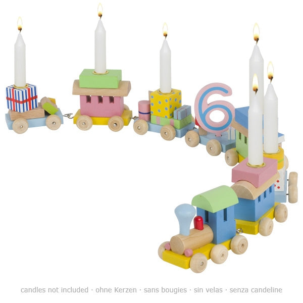 Colorful wooden train cake topper with candles on a white background