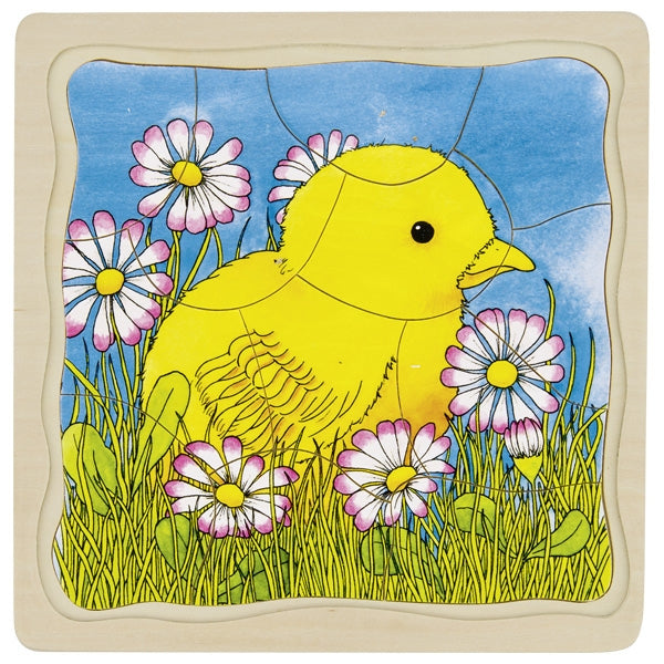 Children's puzzle with a yellow chick and flowers on a blue sky background