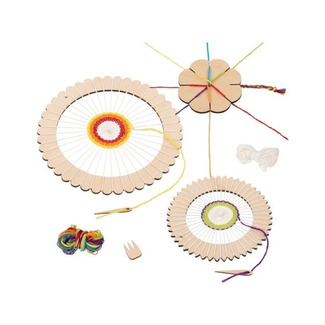 Wooden weaving reels with colorful yarn on a white background